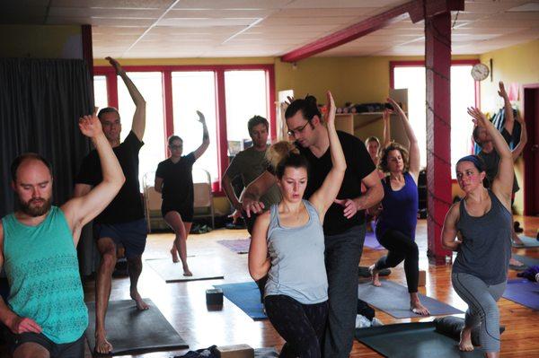 An adjustment offered during a yoga class