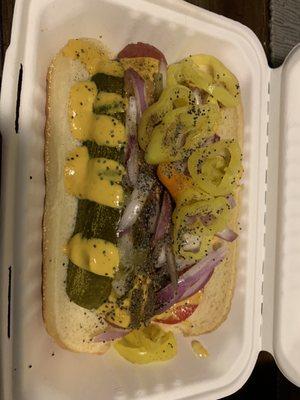 The Chicago dog; mustard, tomato, onion, a pickle spear, pepperocini peppers and more