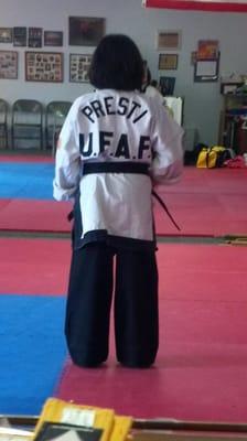 5 minutes after earning her black belt she is wearing my old uniform jacket.