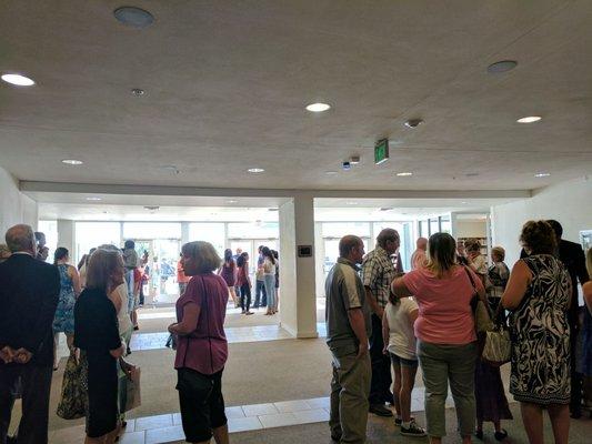 Parishioners visiting with one another in back of church.