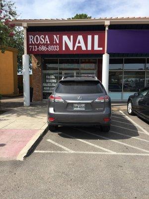 Owner of Rosa n Nails parked in handicap access spot, denying disabled access to entire strip shopping center.