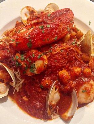 Seafood pasta with spicy marinara sauce over angel hair