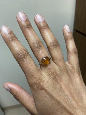 Amber ring with perfectly preserved beetle. Trendy look with the dainty band and round facet.