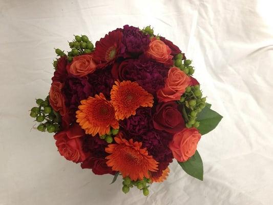 Bridal bouquet of orange gerbera daisies, carnations, roses, & hypericum berry