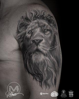 Best Realism style Lion tattoo on upper arm done in black and grey