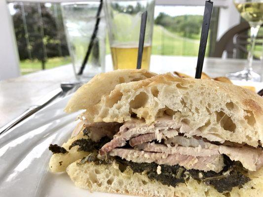 Porchetta and braised kale on ciabatta. With a cold beer overlooking the fairway. My new favorite sandwich.