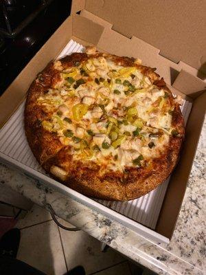 Chicken pizza with Cajun crust, green peppers and banana peppers