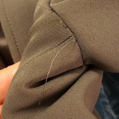 Loose threads under both armpits