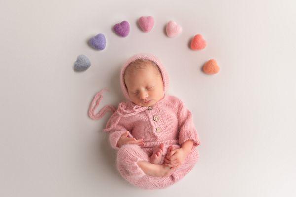 newborn girl with hearts