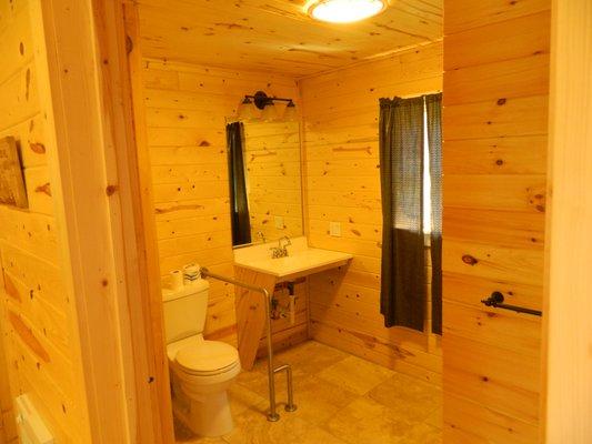 ADA-friendly cabin restroom with back kitchenette