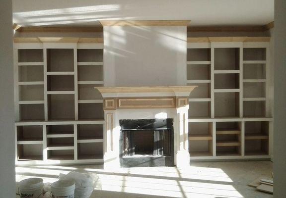 Shelving and fire place mantle build with wood trim!