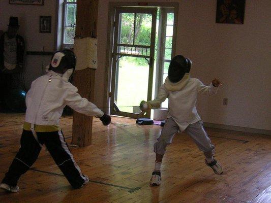 Fencing classes, private and group for children and adults of all ages. These two are fencing "dry" without electrical equipment.