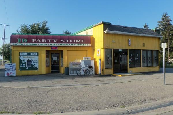 On the left is JB Party Store, on the right is Maria's Barber Shop.