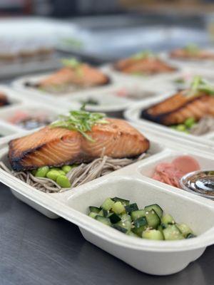 Miso glazed wild salmon with soba noodles and edamame served with sunamono salad, pickled ginger and a coconut amino dressing