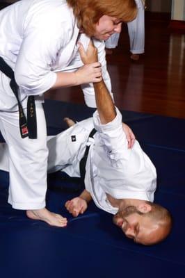 Practical and effective self-defense...Mrs. Nelson teaching a restraint hold in the adult class.