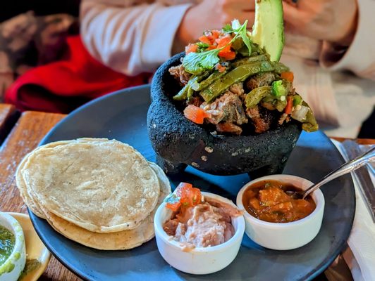 December 31, 2022; Molcajete de carnitas ($19).