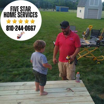 Our customer's two year-old, Dominic, meeting his hero, Dustin, on the deck that our team built for them! Dominic watched them all day!