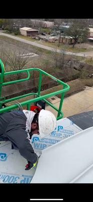 Roofer working on a commercial metal roof