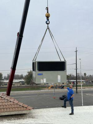 Crane lift for multiple unit replacements at a commercial building.