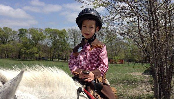 Young cowboy on a pony ride.