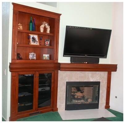 Custom fireplace mantle with audio display Alder wood cabinet.