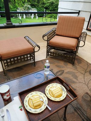 Enjoying homemade lemon curd cake on the balcony of our room with view of the front lawn in the foreground.