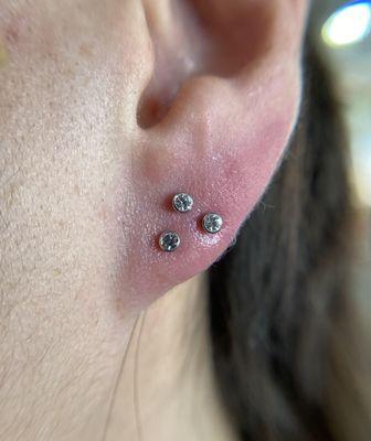 Triple Stacked Lobe Piercing with Titanium 2mm Cubic Zirconium Bezel sets.