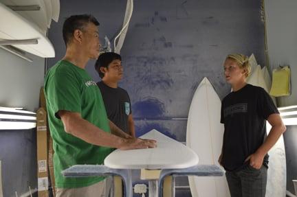 T&C team riders Finn McGil and Kekoa Balcaso talk shop with shaper Glenn Pang.