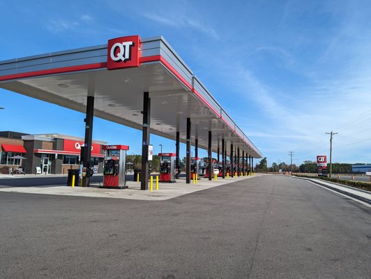 Outside the gas station. 20 pumps for cars. Truck stop in back. Street sign on far right in this photo.