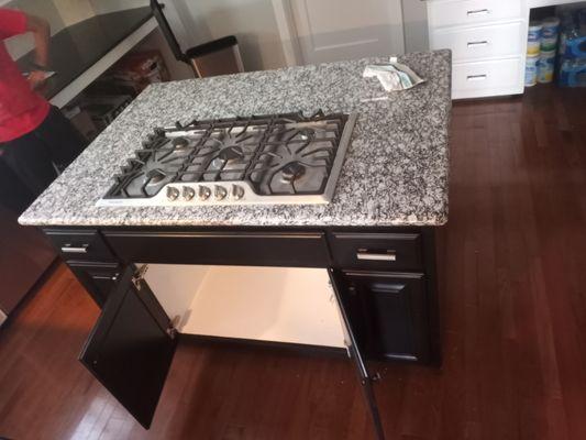 Installation of small center cabinets, countertop and stove in our client's kitchen.