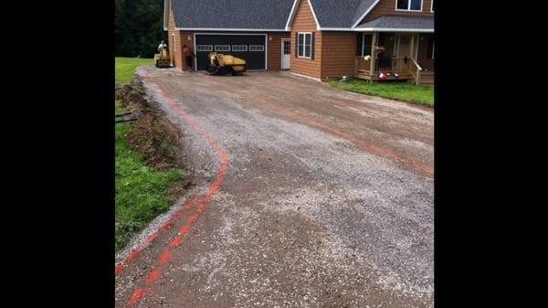 Crushed rock is leveled compacted and graded. Guide lines are sprayed and ready to go for new asphalt...