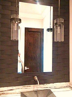 arched tile backsplash and mirror surround in a powder bath