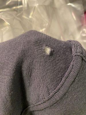 Hole in the dry cleaned sweater when back