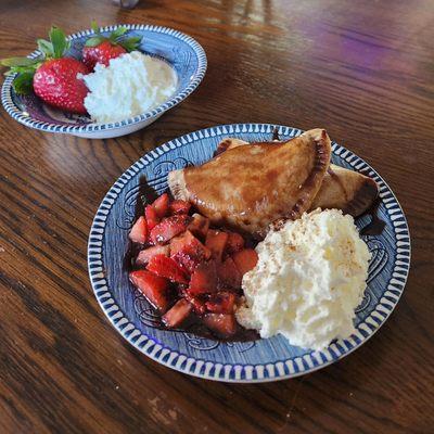 Sweet Cheese Pierogi + Graham Cracker Dough paired with chocolate sauce, strawberries, whipped cream, and sprinkle of cinnamon.