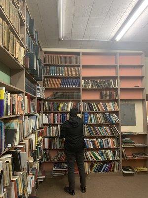 my friend next to an amazing selection of books, i found a biography of Jung on the bottom left of the shelf my friend is facing