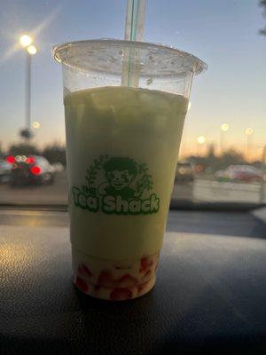 Honey dew milk tea with coconut powder and strawberry jelly