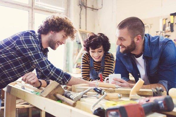 Eva, Derrick and William having fun building one of our Rustic-Wellford Platform beds, at the plant.