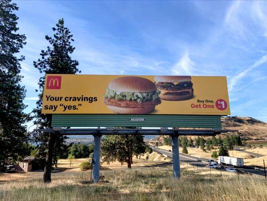 Cars driving past McDonald's billboard advertising a McChicken outside of The Dalles, Oregon