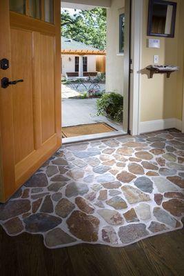 entry way with natural stone and hardwood floor