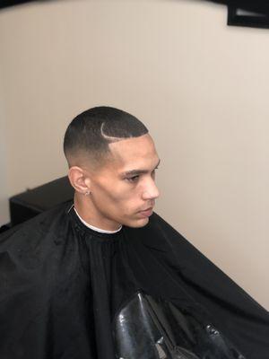 High bald fade with a curve part