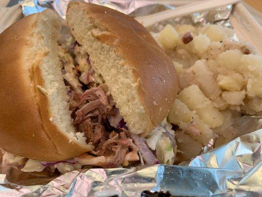 Pulled pork sandwich w/ pig candy coleslaw and side of German potato salad