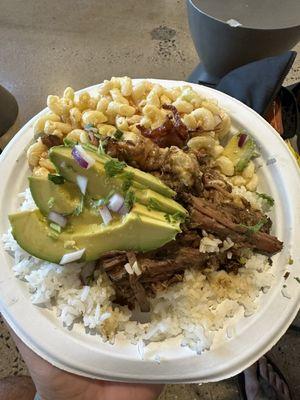 Beef birria plate lunch served with rice, Mac salad, and cheese skirt under the birria!