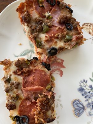 All meat pizza with added olives and pepper