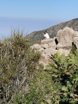 Sitting on the rock to get a better picture.