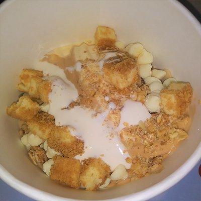 Cake batter and peanut butter swirl yogurt, cheesecake pieces, granola, and marshmallow topping.