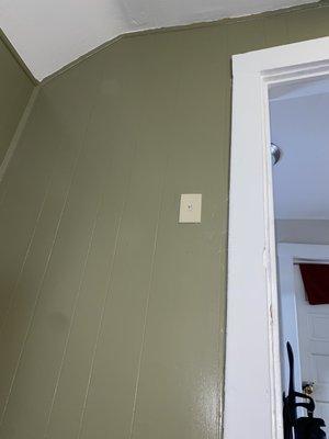 Patch mud and drywall tape around light switch and primed and painted and room Deep Olive