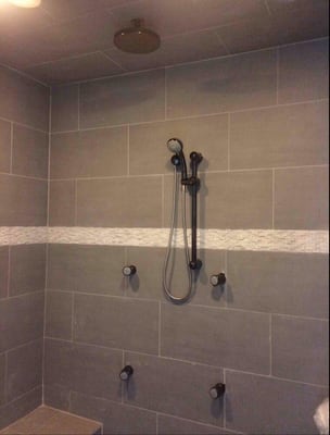 Shower installation with body sprays and rain head.