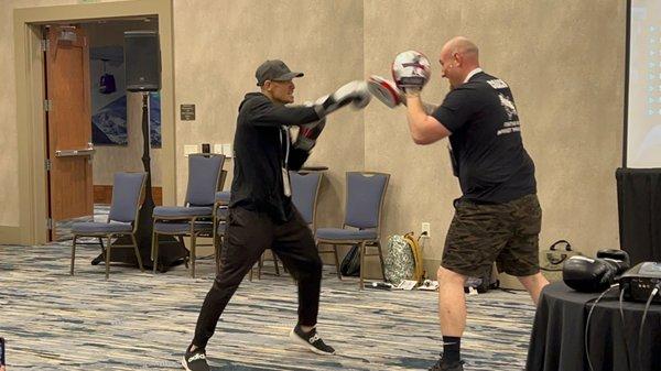 Coach Rafi Doing mittwork at the Rock Steady Boxing Annual conference in CO