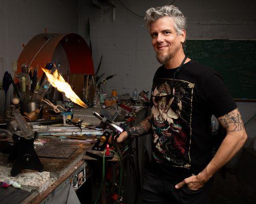 Environmental Portrait of Josh Poll glass artist at his work bench