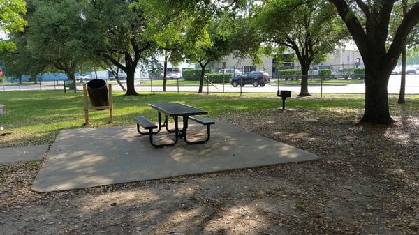 Picnic area with bbq pit under a few matured trees